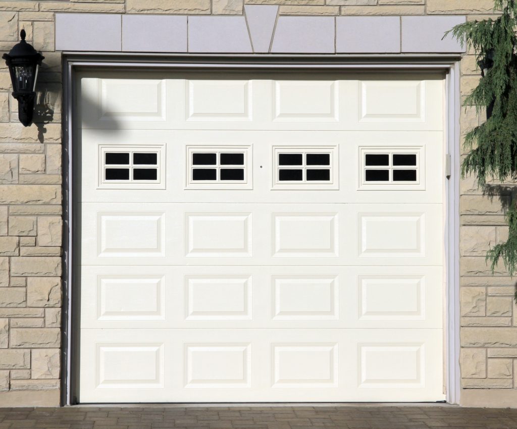 White garage door of a detached house