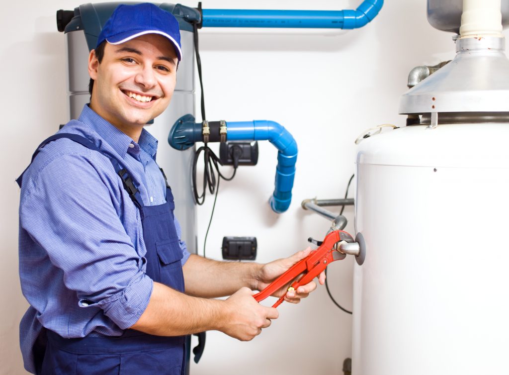 A repairman fixing a water heater