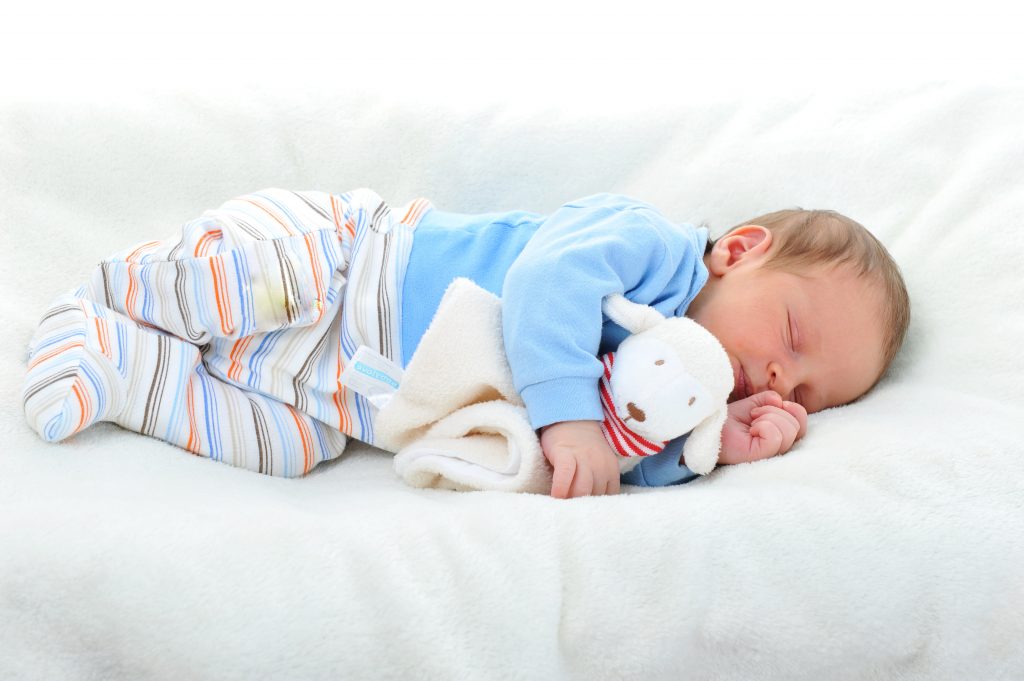 Cute baby sleeping on a comfortable bed