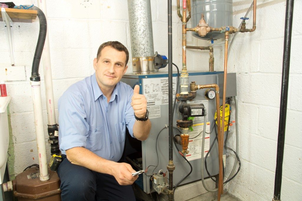 Plumber fixing the gas furnace