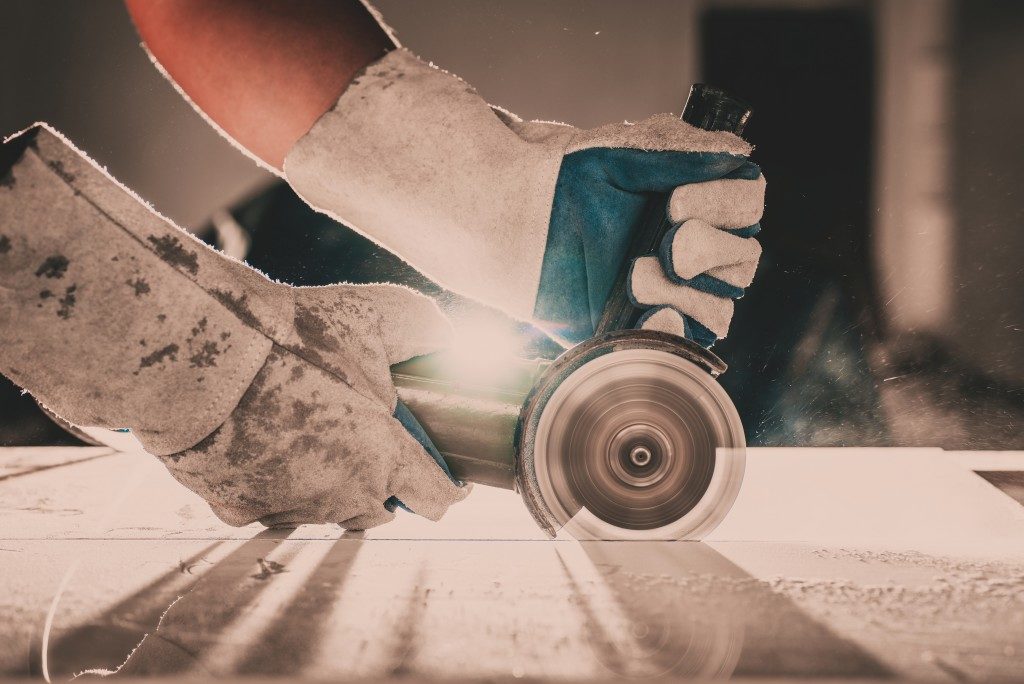 Man cutting tile