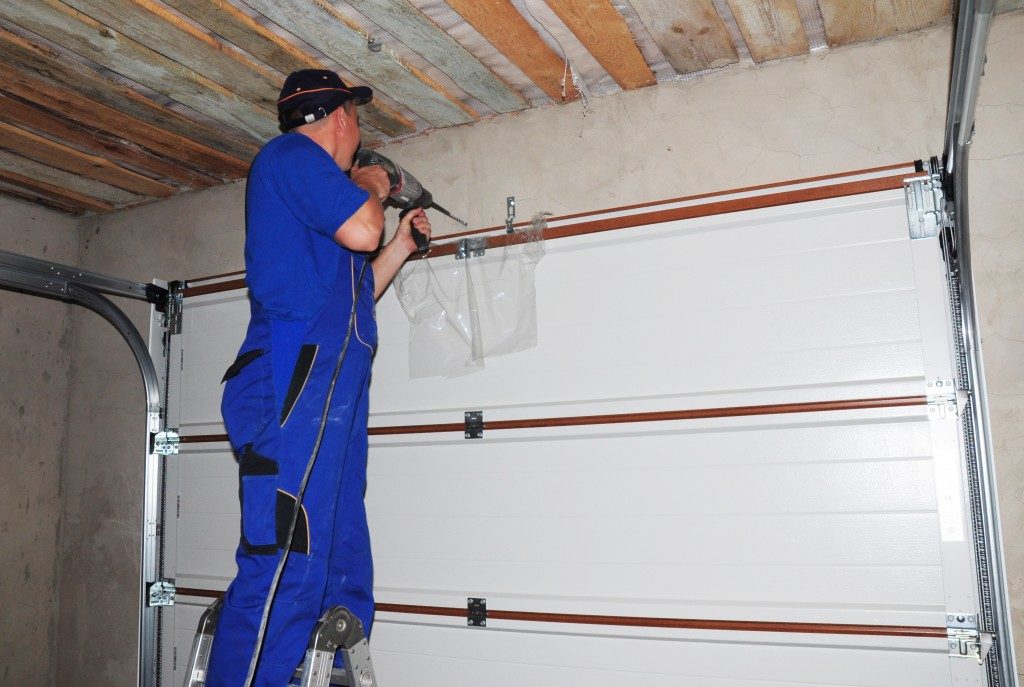 man installing garage door system