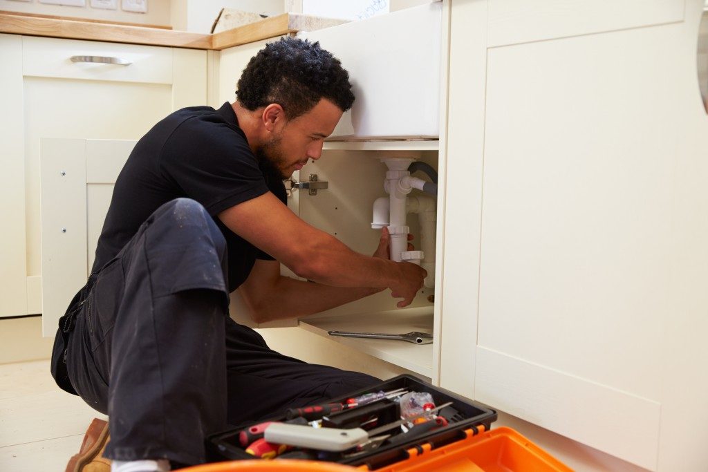 man fixing the plumbing