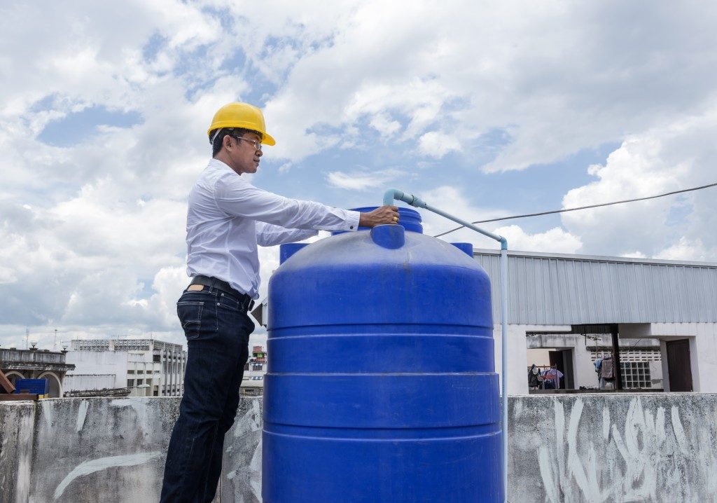 Tank Inspections- Worker inspecting the water storage tank