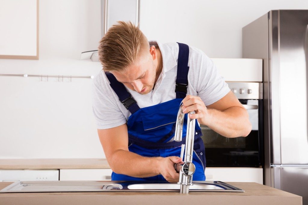 plumber installing faucet