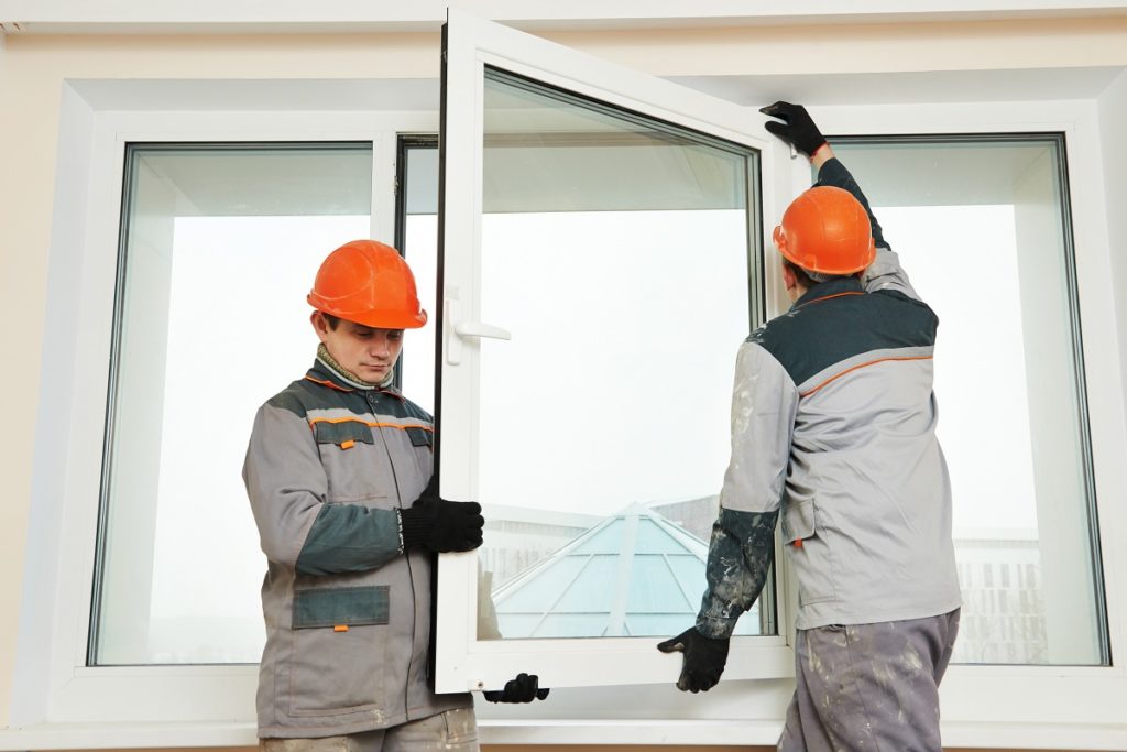 Workers replacing a window