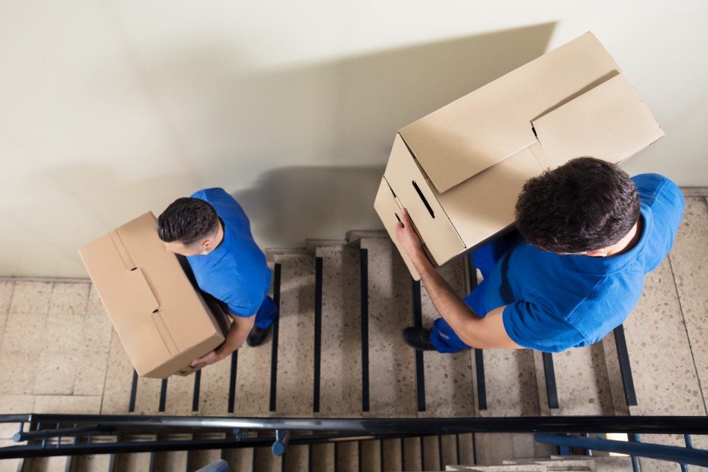 Movers each carrying boxes