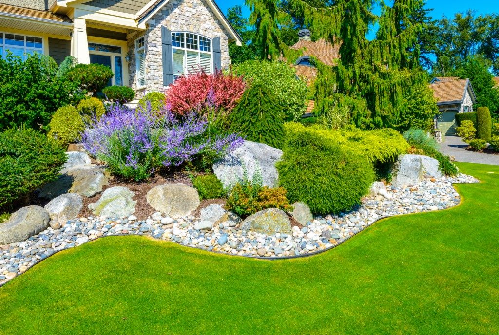 Flowersd and stones in front of the house