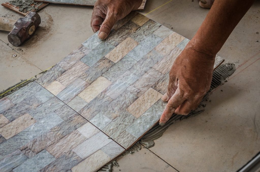 person installing tiles