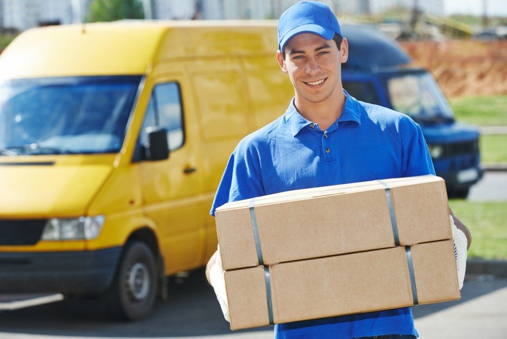 Delivery man with container van in the back