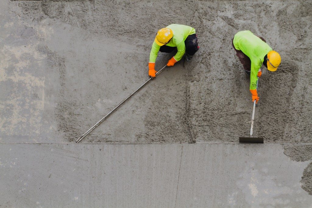 Men smoothing out the concrete