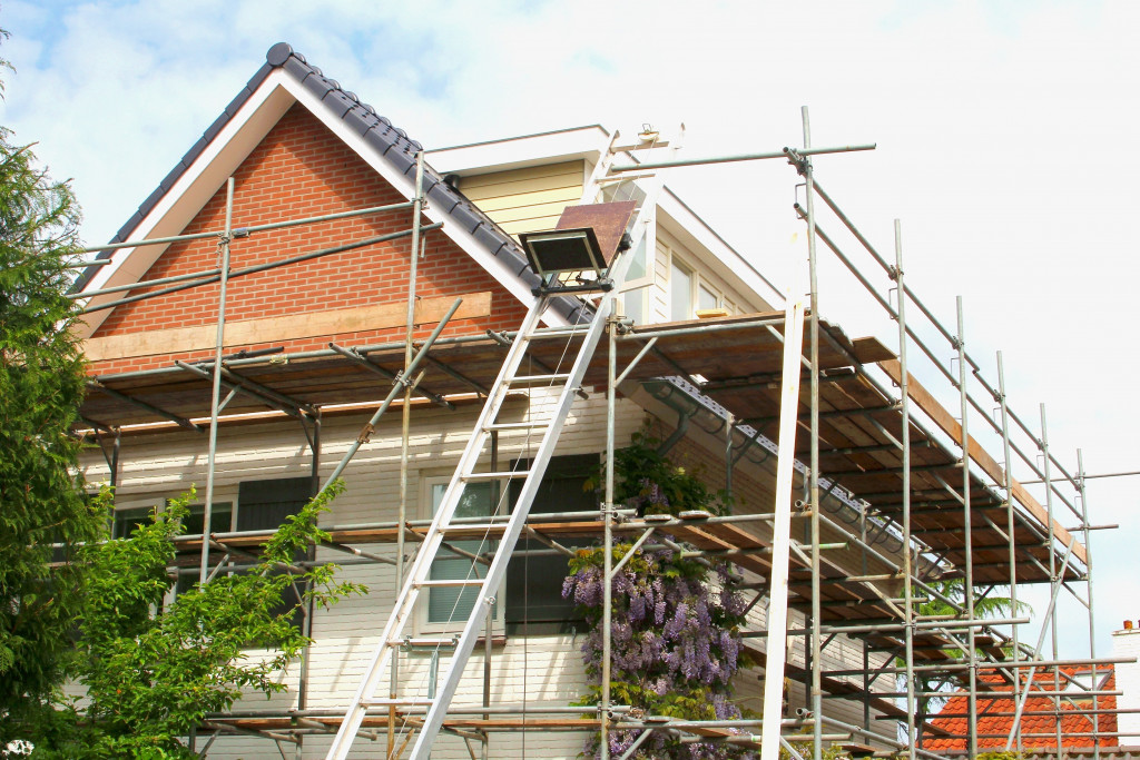 white house with scaffoldings around it