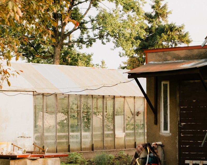 a greenhouse beside a house